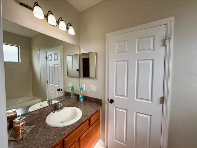 a spacious bathroom with a double vanity sink and a mirror