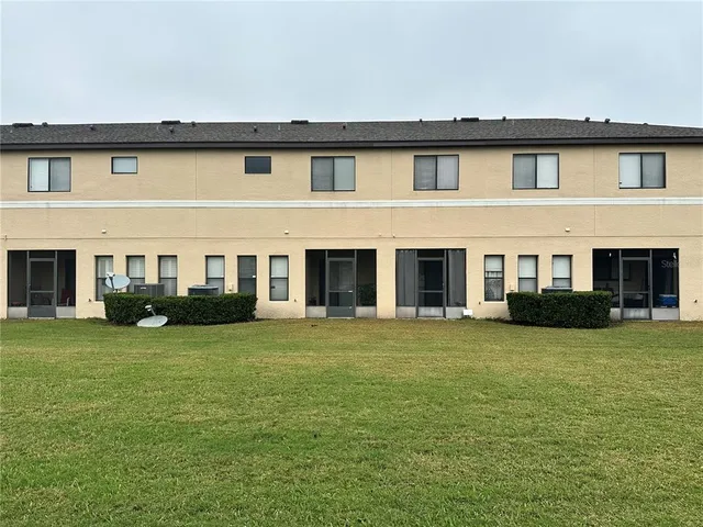 a view of a house with a yard patio and swimming pool
