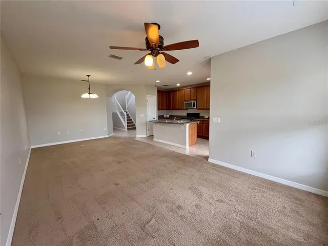 a view of a kitchen with a sink cabinets and stainless steel appliances