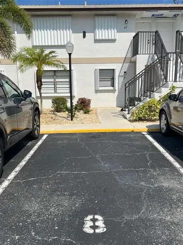 a view of a car park in front of house