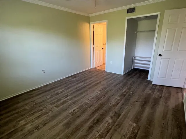 a view of a room with wooden floor