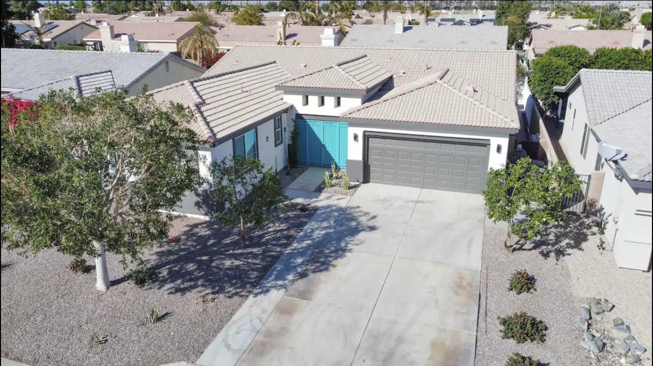 an aerial view of a house with a yard and a garage