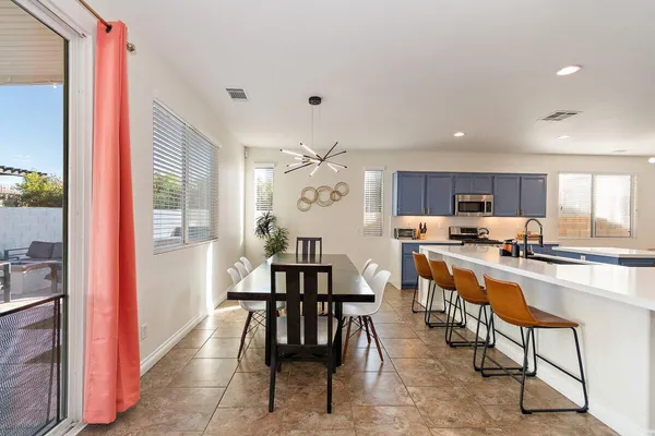 a large kitchen with a table and chairs