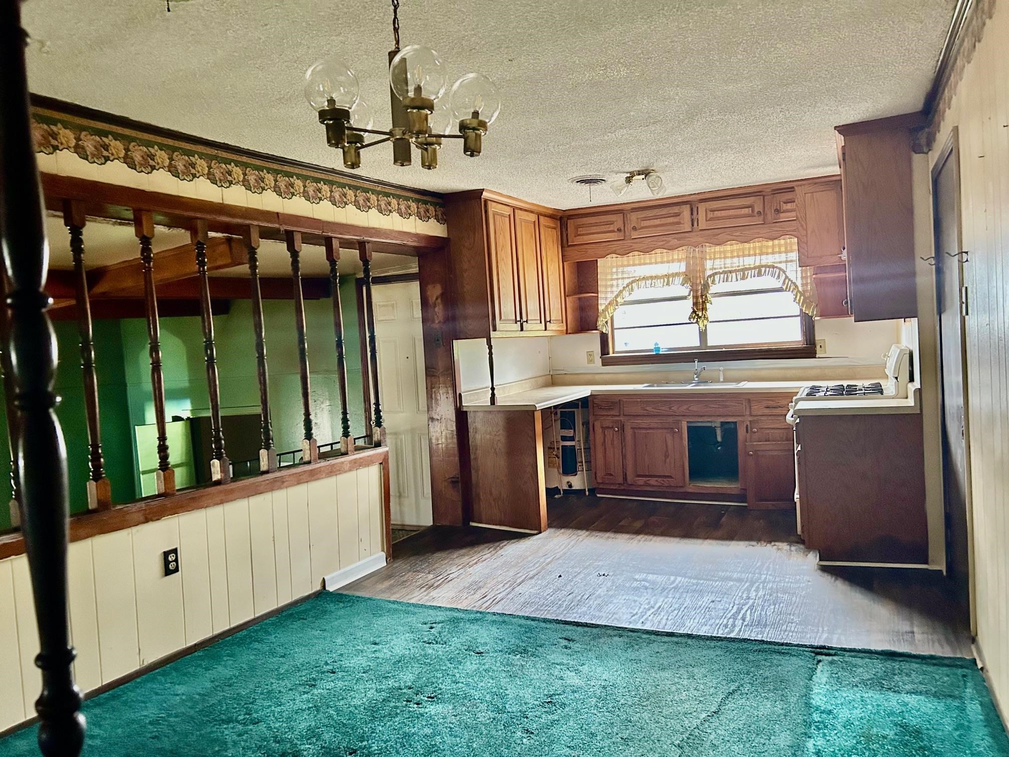 409 Hill Avenue Covington, TN 38019 - Photo 2 of 11 a large kitchen with stainless steel appliances granite countertop a stove and a view of living room