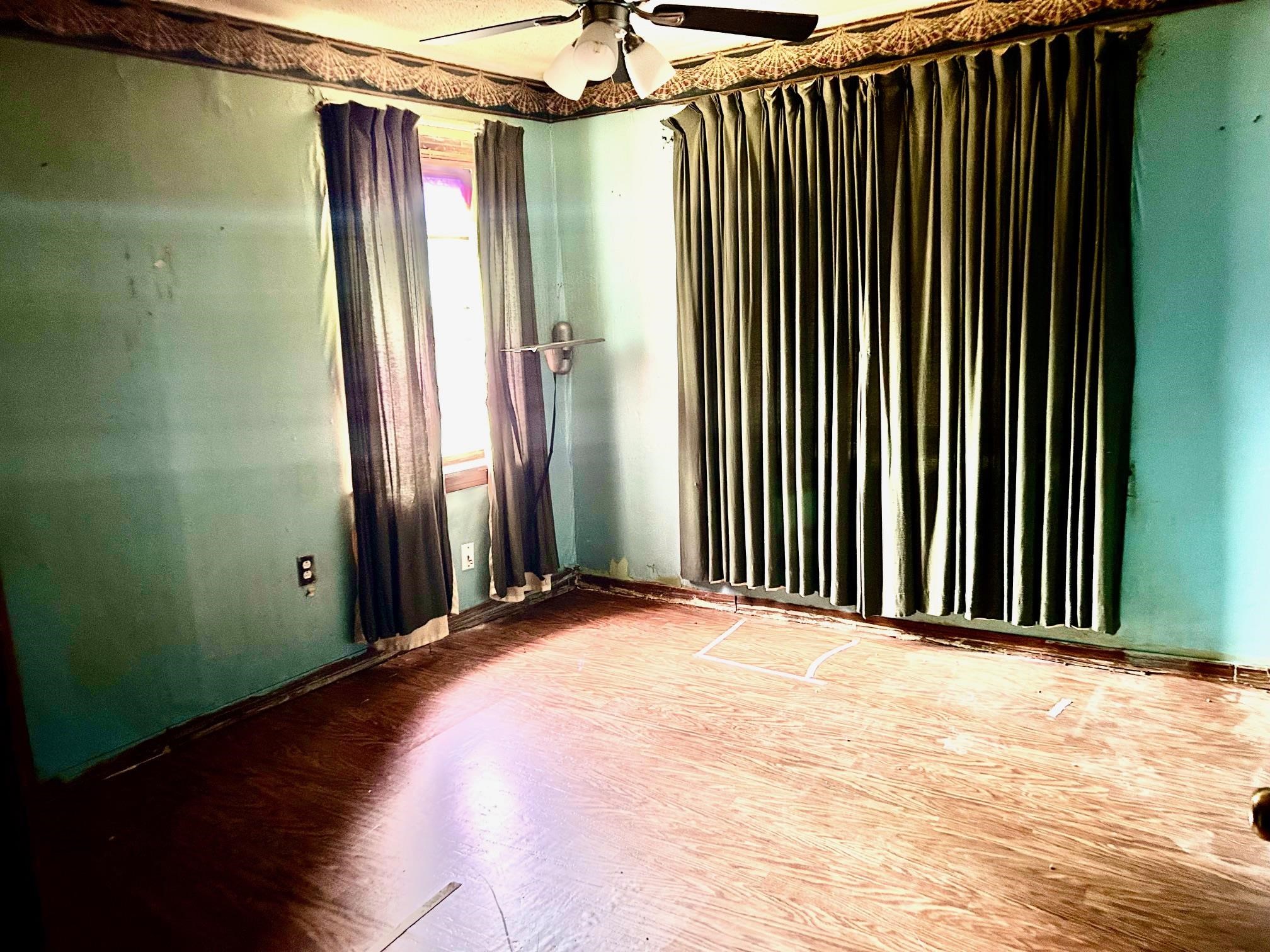 409 Hill Avenue Covington, TN 38019 - Photo 6 of 11 a view of a room with a wooden floor and a window