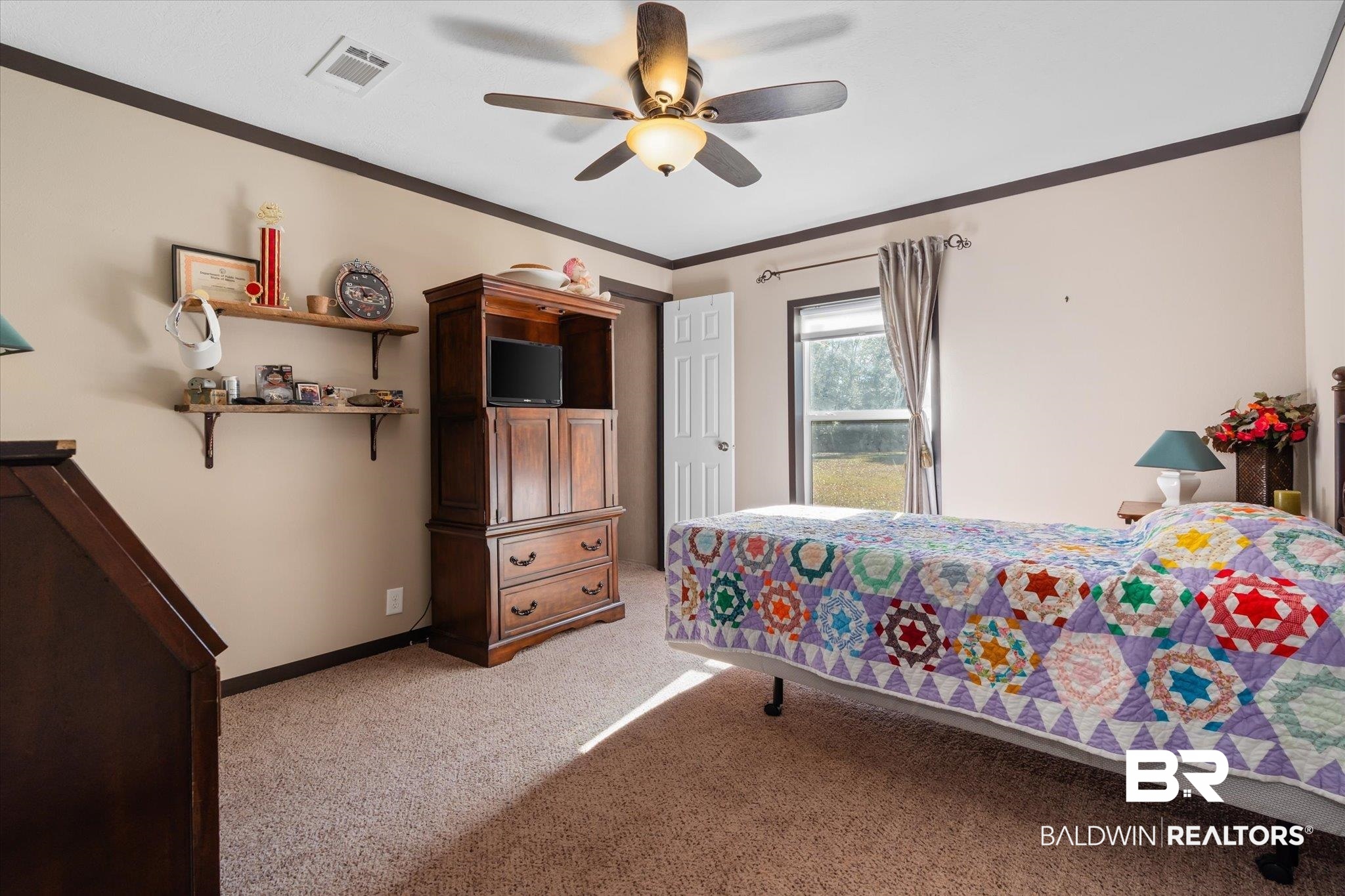 15635 County Road 83 Elberta, AL 36530 - Photo 37 of 54 Bedroom with ceiling fan, light colored carpet, and crown molding