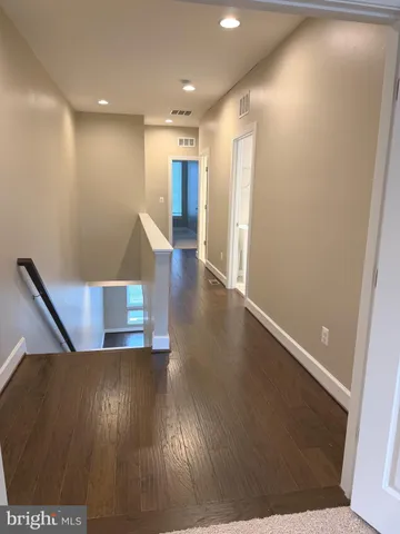 a view of room with window and wooden floor