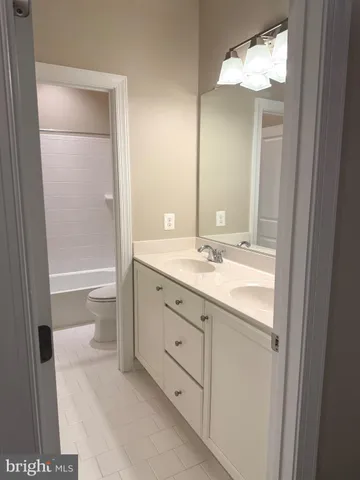 a bathroom with a shower toilet and sink