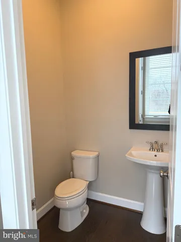 a view of a kitchen with wooden floor and a refrigerator