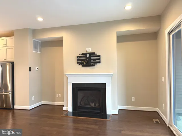 a kitchen with stainless steel appliances granite countertop a sink a refrigerator and a counter top space