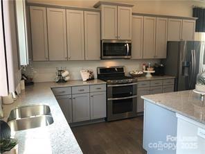 1138 Doveridge Street Charlotte, NC 28273 - Photo 1 of 22 a kitchen with a sink stove and microwave
