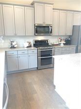 1138 Doveridge Street Charlotte, NC 28273 - Photo 2 of 22 a kitchen with granite countertop white cabinets and stainless steel appliances