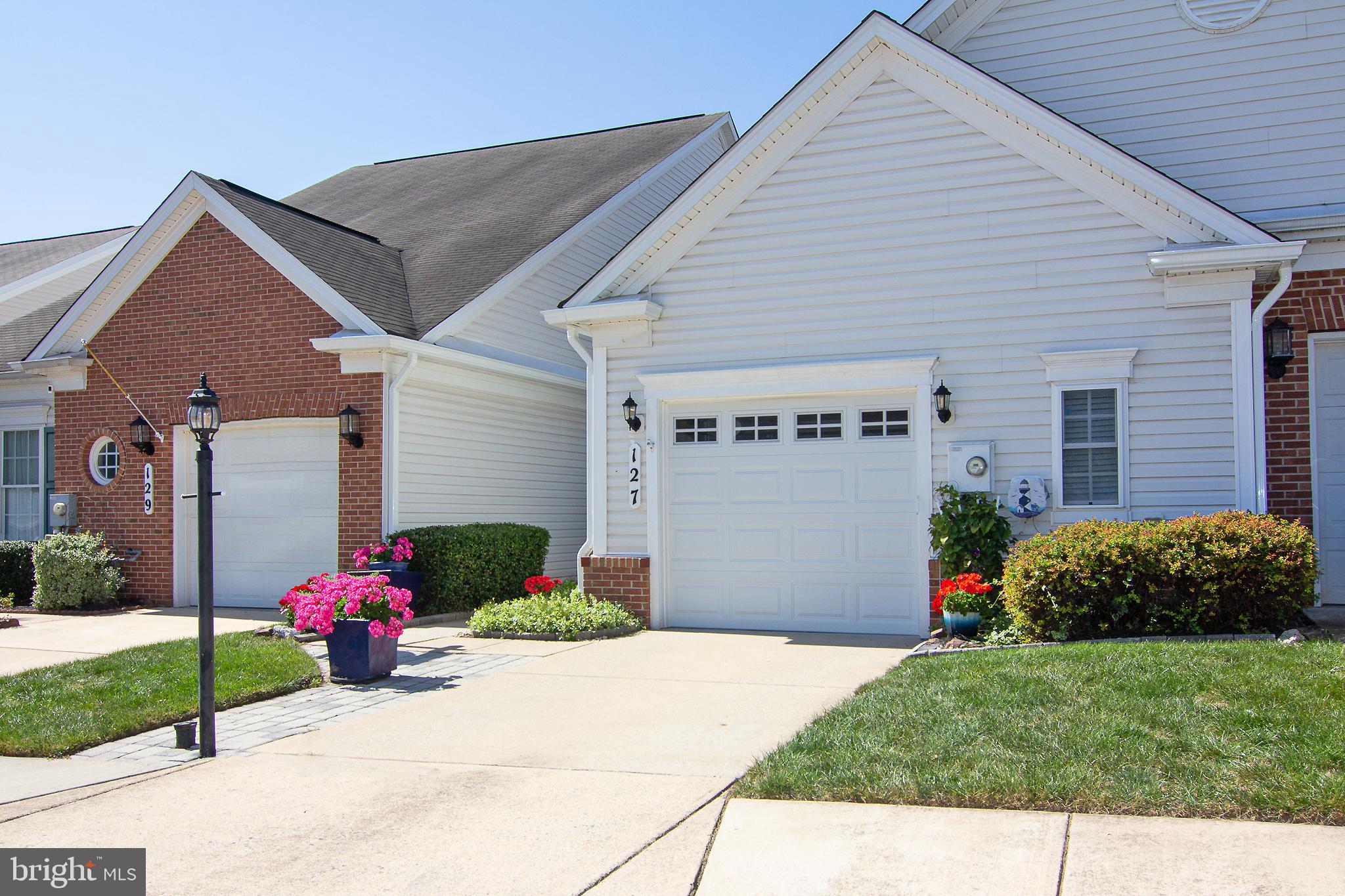 127 Ponytail Lane, Unit 133 Taneytown, MD 21787 - Photo 1 of 24 a front view of a house with a yard and garage
