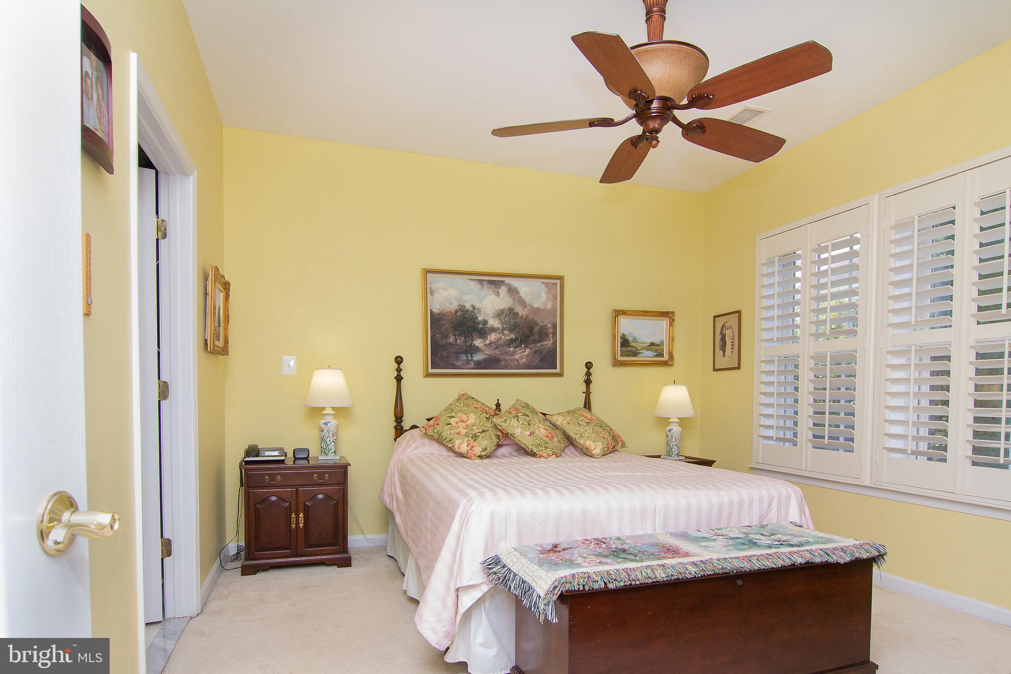 127 Ponytail Lane, Unit 133 Taneytown, MD 21787 - Photo 18 of 24 a bedroom with a bed and a chandelier