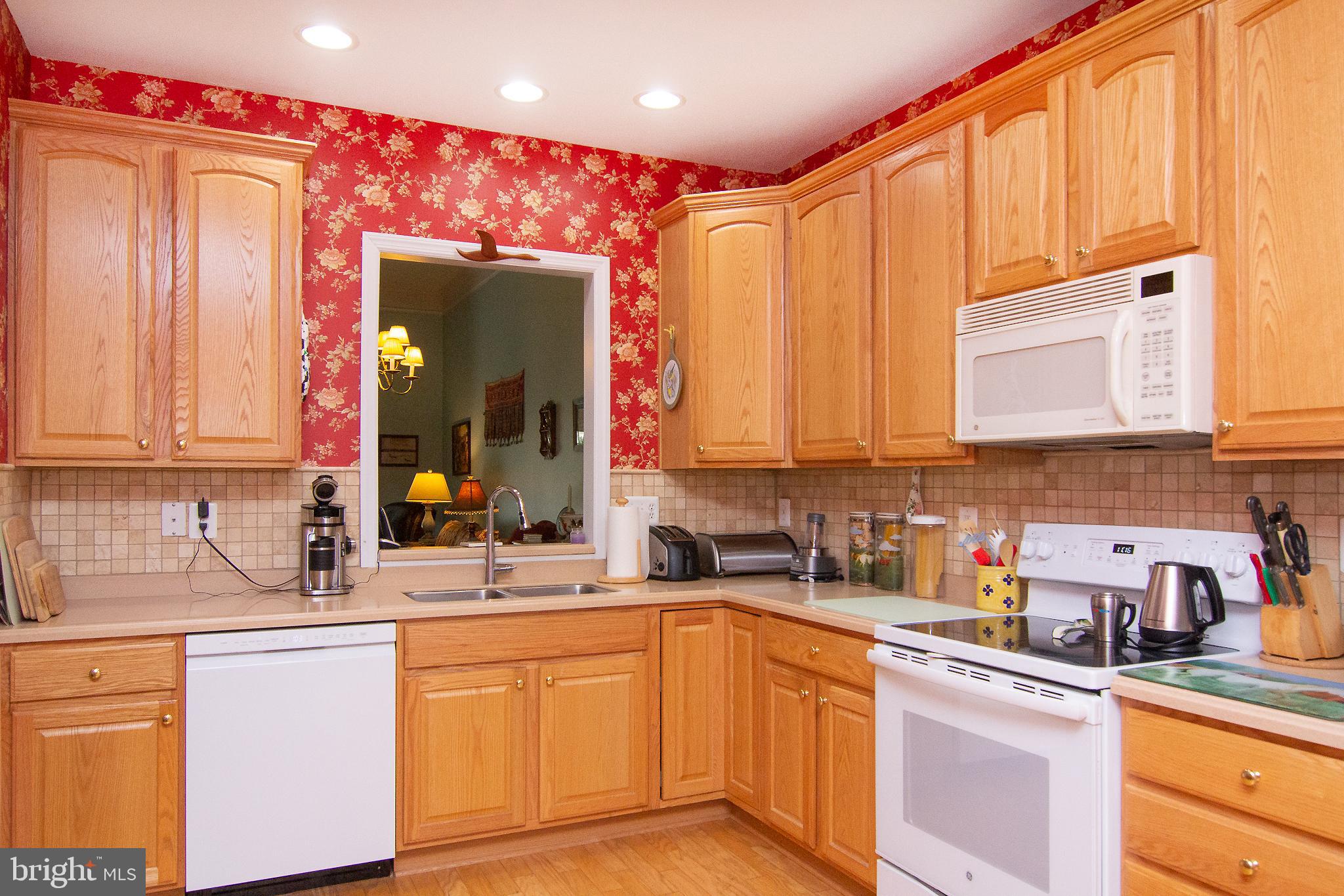 127 Ponytail Lane, Unit 133 Taneytown, MD 21787 - Photo 9 of 24 a kitchen with stainless steel appliances granite countertop a sink stove and cabinets