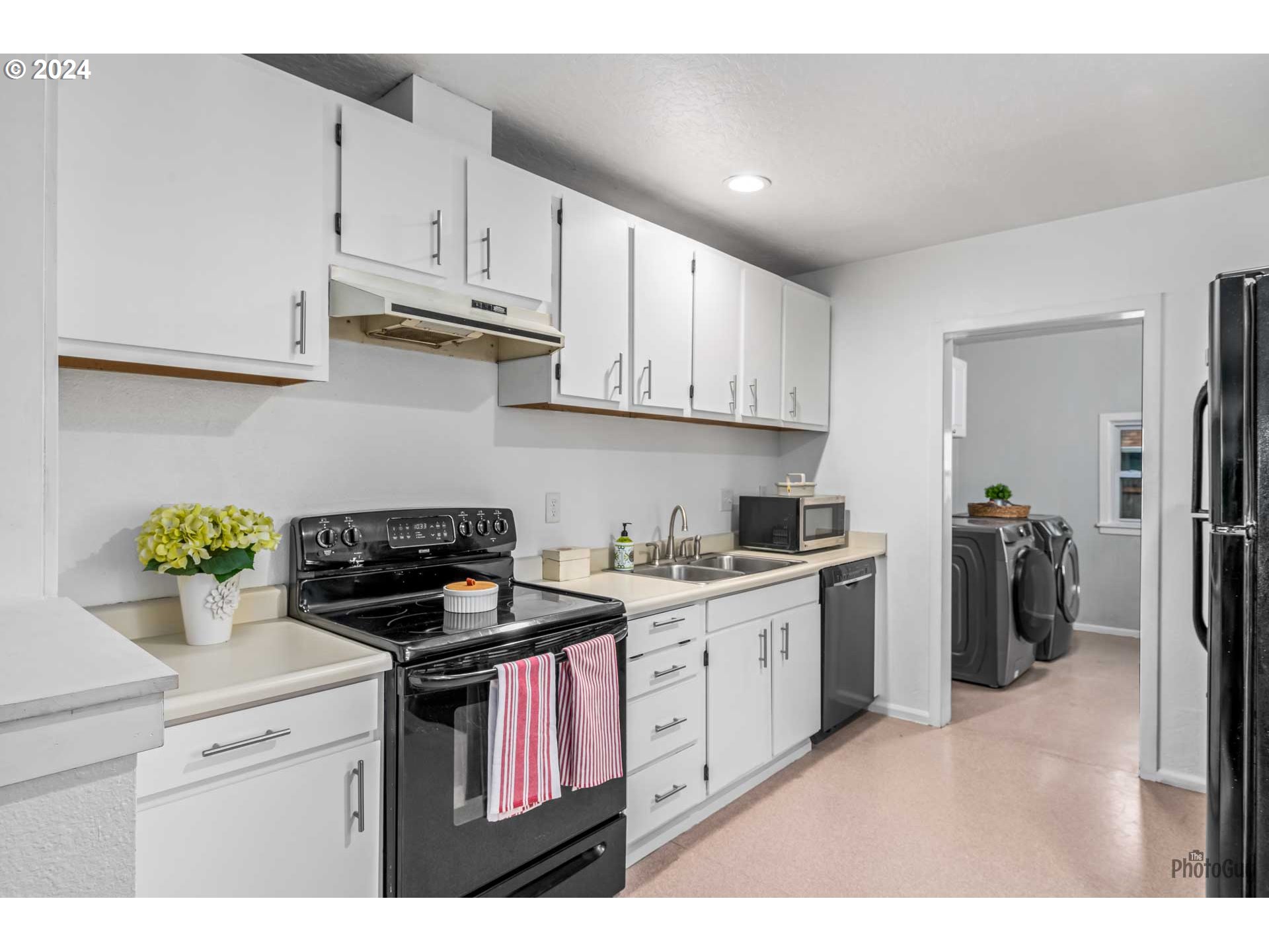 834 26th Street Springfield, OR 97477 - Photo 8 of 23 a kitchen with stainless steel appliances granite countertop a stove a refrigerator and a white cabinets