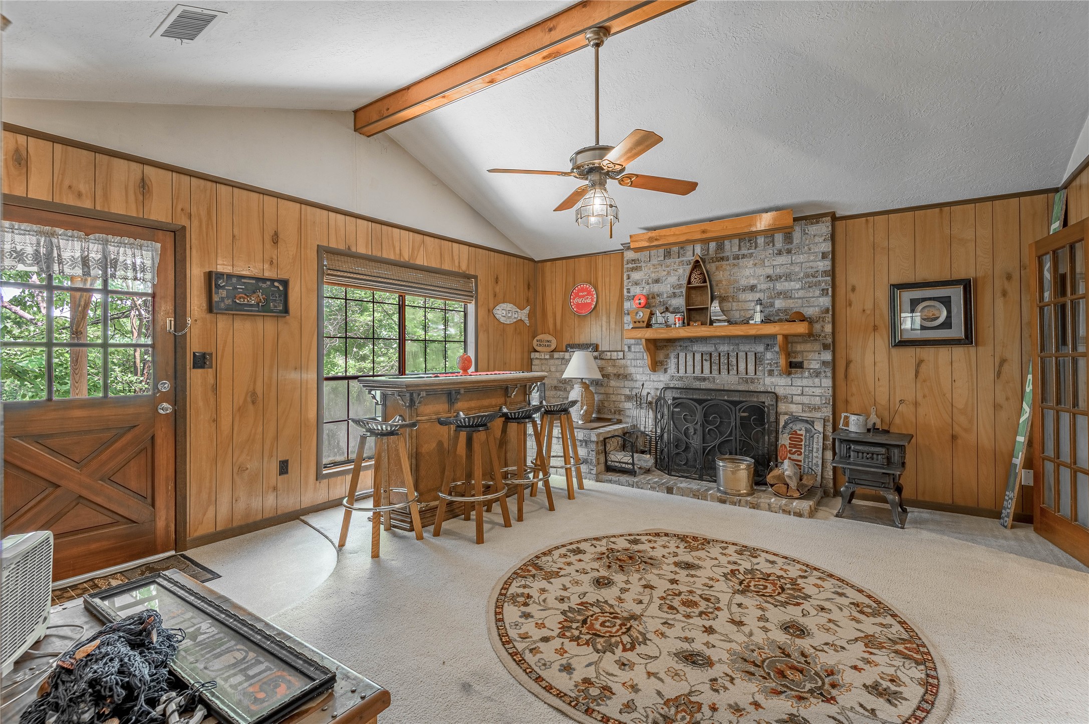 109 Hill Top Road Huntsville, TX 77320 - Photo 15 of 38 a living room with furniture a fireplace and a flat screen tv