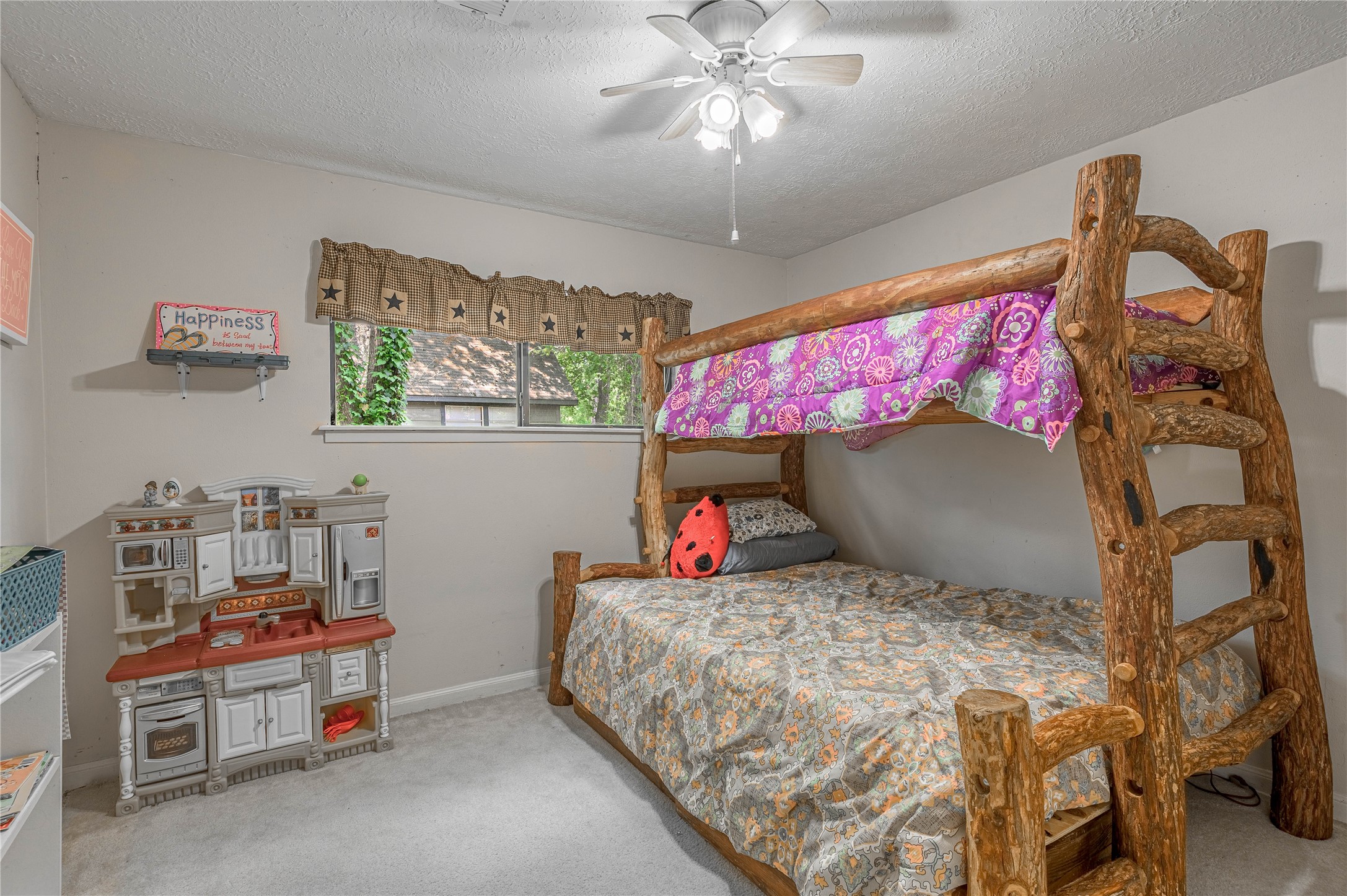 109 Hill Top Road Huntsville, TX 77320 - Photo 17 of 38 a bedroom with a bed and a chandelier