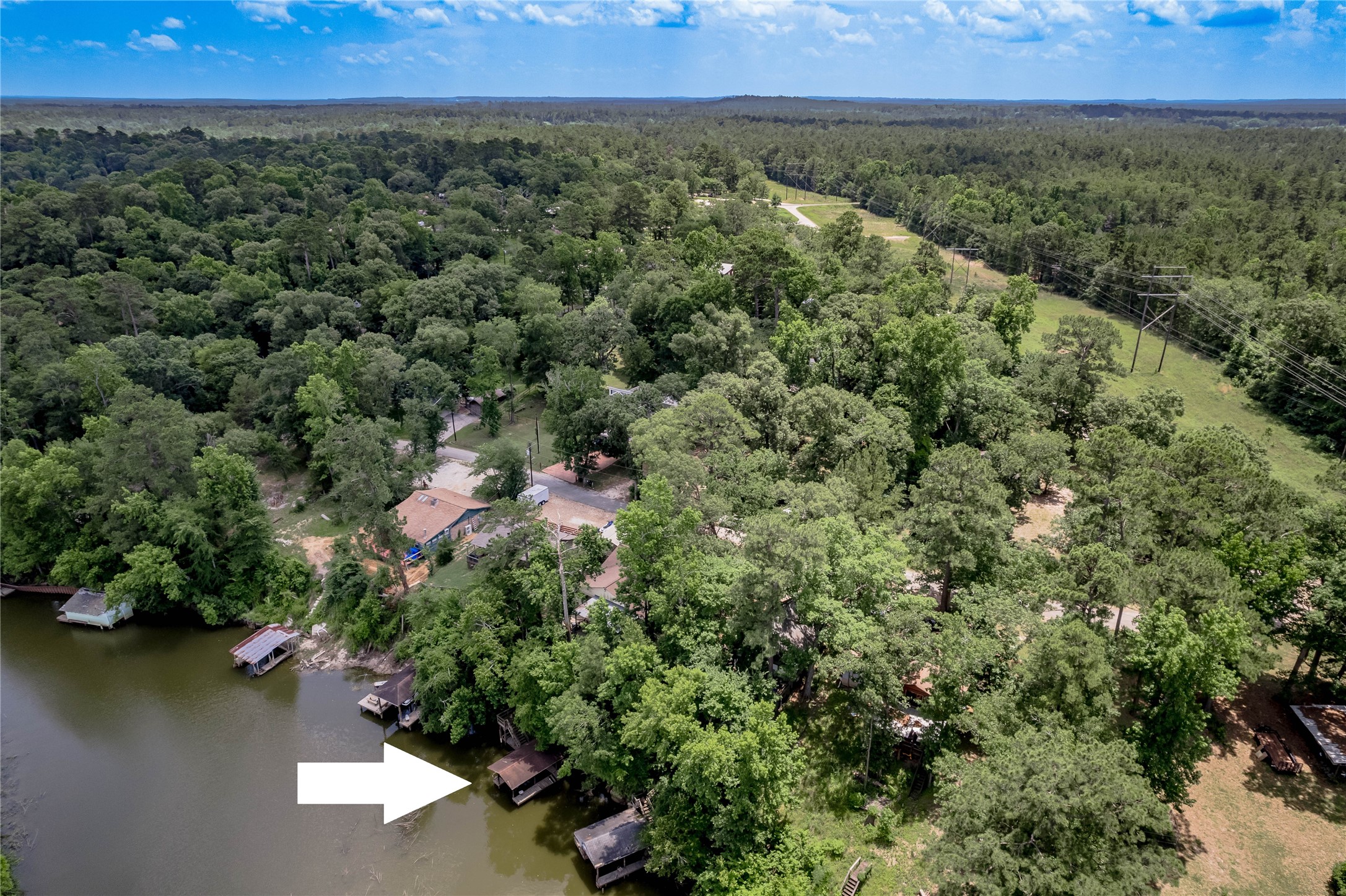 109 Hill Top Road Huntsville, TX 77320 - Photo 2 of 38 an aerial view of a houses with a yard and lake view