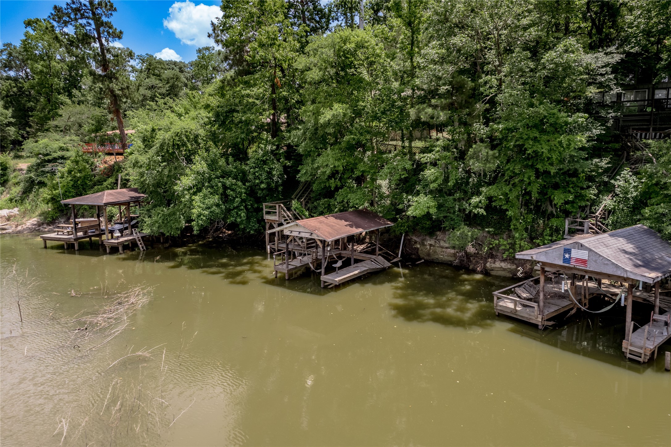 109 Hill Top Road Huntsville, TX 77320 - Photo 34 of 38 a view of a lake with parked cars