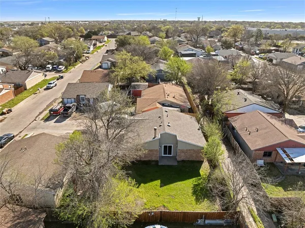 an aerial view of residential houses with outdoor space