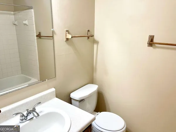 a white toilet sitting next to a bathroom sink