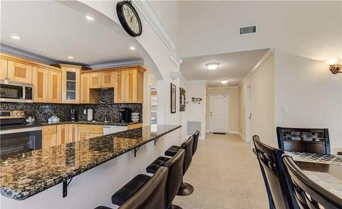 a kitchen with stainless steel appliances granite countertop a sink and a wooden floors