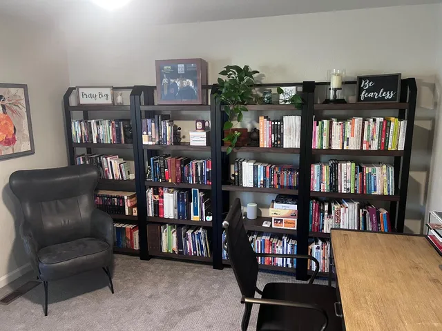 a living room with large lots of furniture and a book shelf
