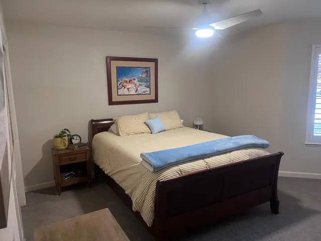 a bedroom with a bed and a table