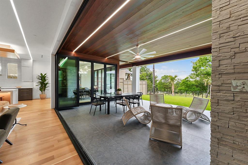 9457 Waterview Road Dallas, TX 75218 - Photo 11 of 25 Covered outdoor living area featuring a wood-finish ceiling with integrated lighting and a ceiling fan