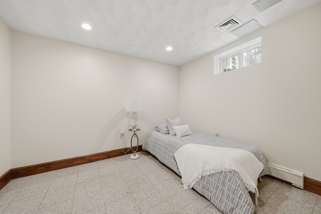 131 Range Heights Road Lynn, MA 01904 - Photo 24 of 36 a room with a bed and a night stand