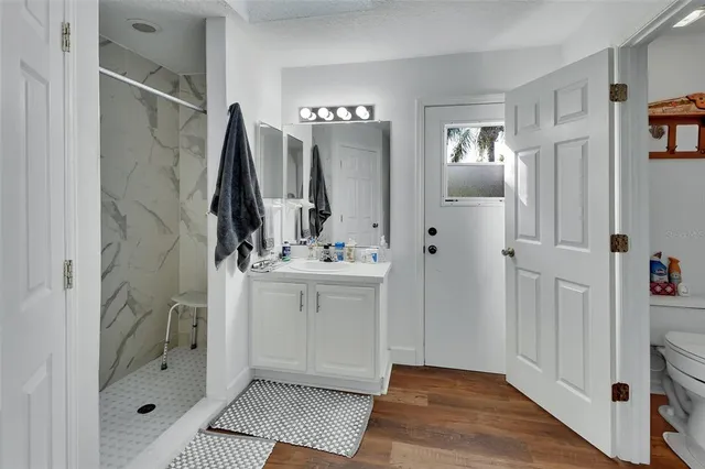 a bathroom with a double vanity sink a mirror and a shower