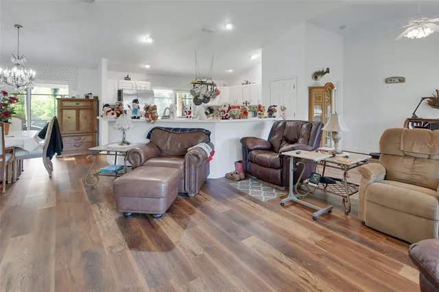a living room with furniture and a chandelier