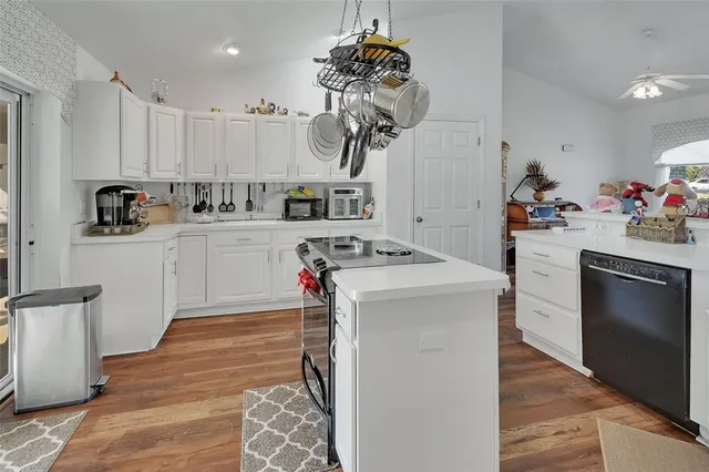 a kitchen with a sink cabinets and appliances