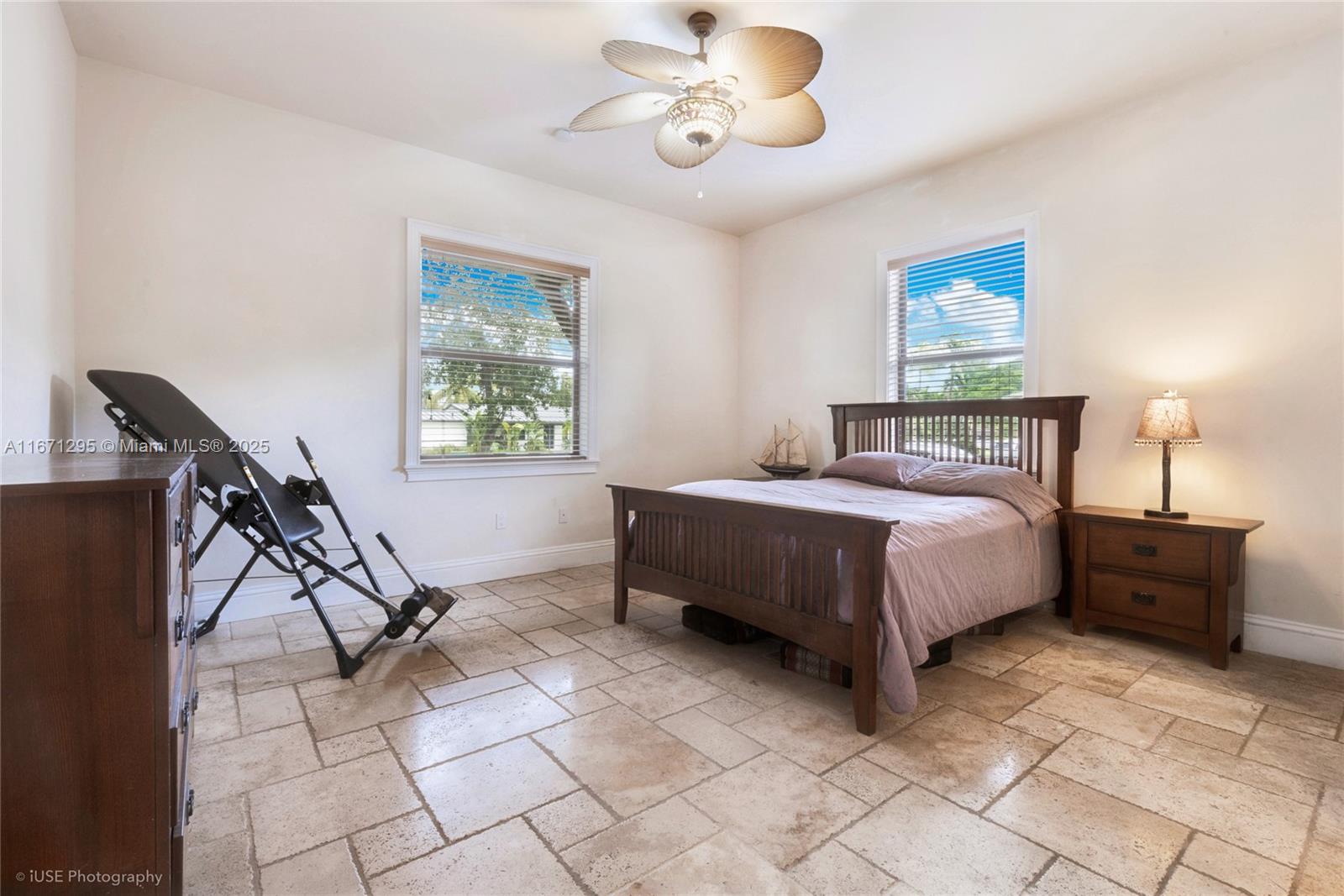 8240 Southwest 98th Street Miami, FL 33156 - Photo 10 of 17 a bedroom with a bed and a chandelier