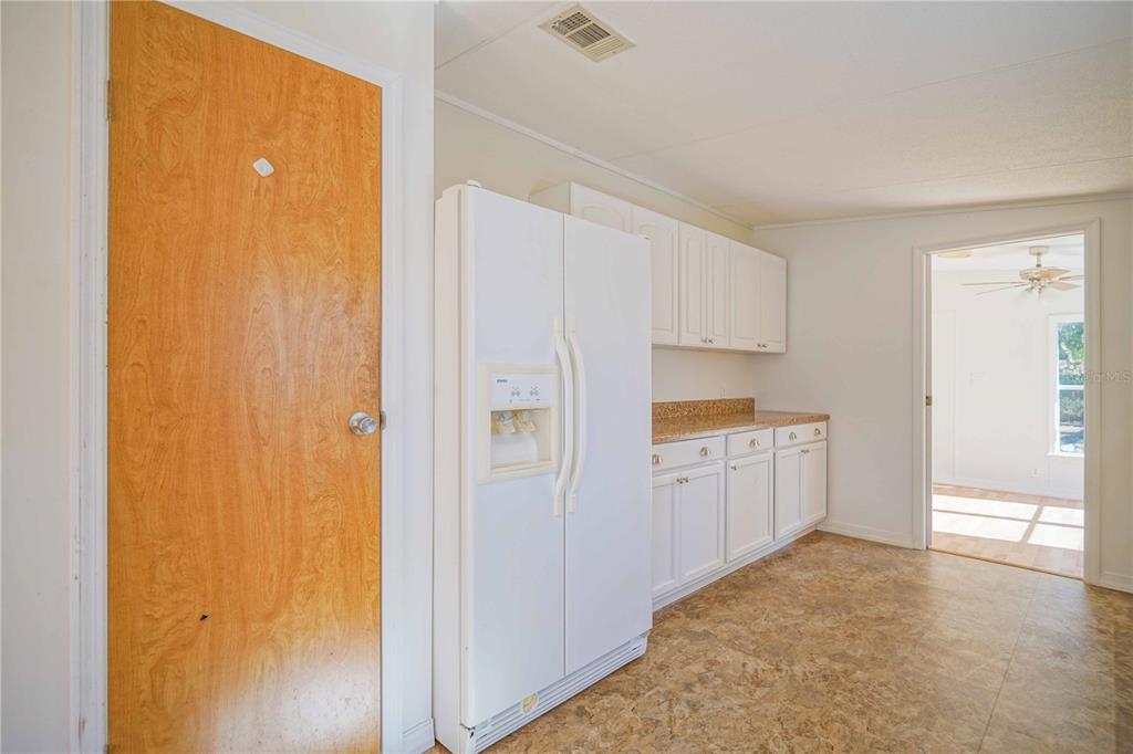 16621 Southwest 45th Street Ocala, FL 34481 - Photo 20 of 52 a kitchen with white cabinets and white appliances