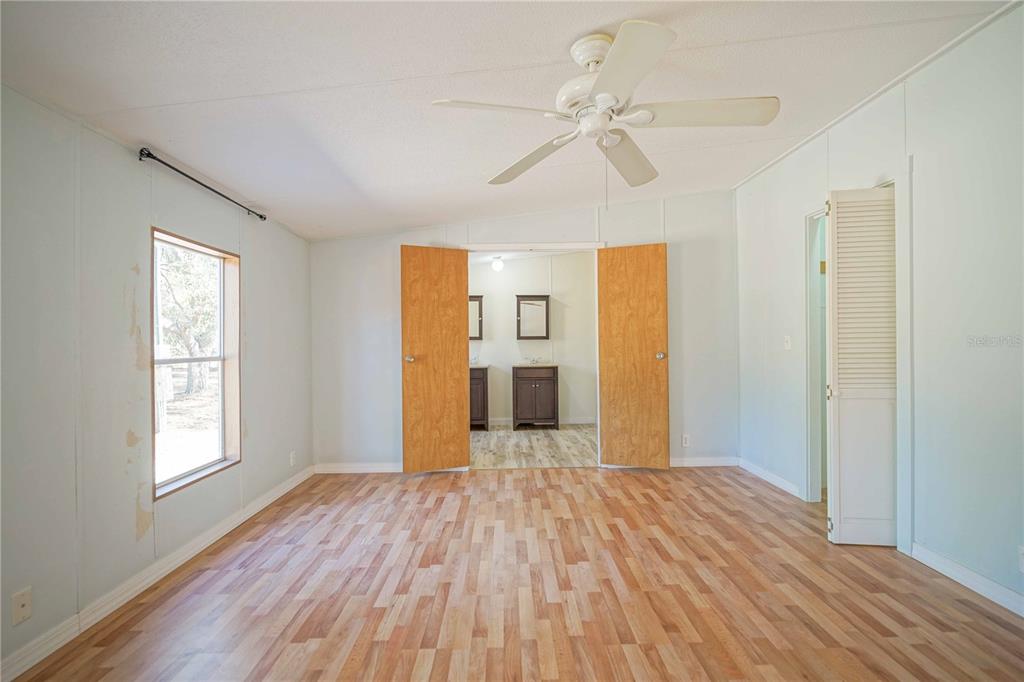 16621 Southwest 45th Street Ocala, FL 34481 - Photo 24 of 52 wooden floor in an empty room with a window