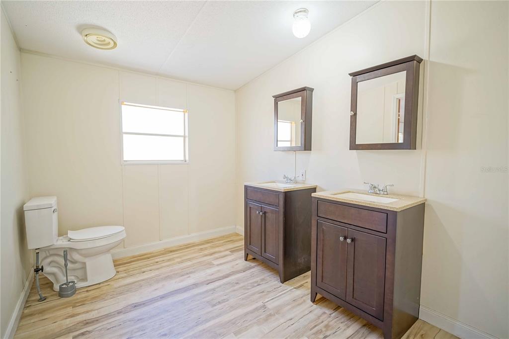 16621 Southwest 45th Street Ocala, FL 34481 - Photo 28 of 52 a bathroom with a sink a toilet and mirror