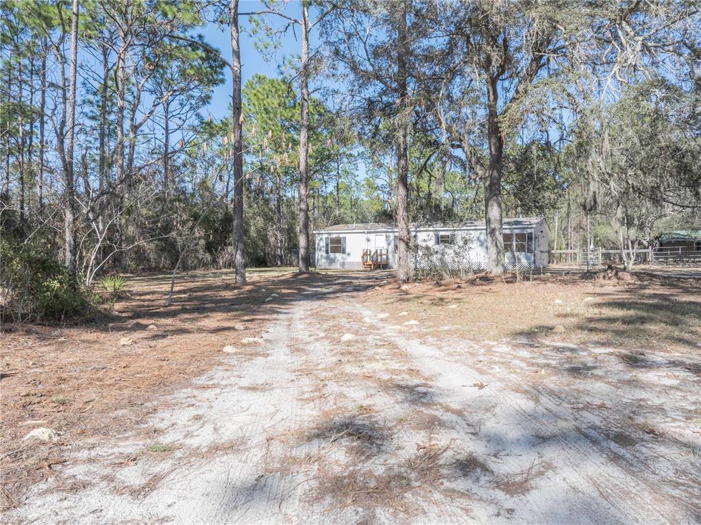 16621 Southwest 45th Street Ocala, FL 34481 - Photo 3 of 52 a view of road and trees
