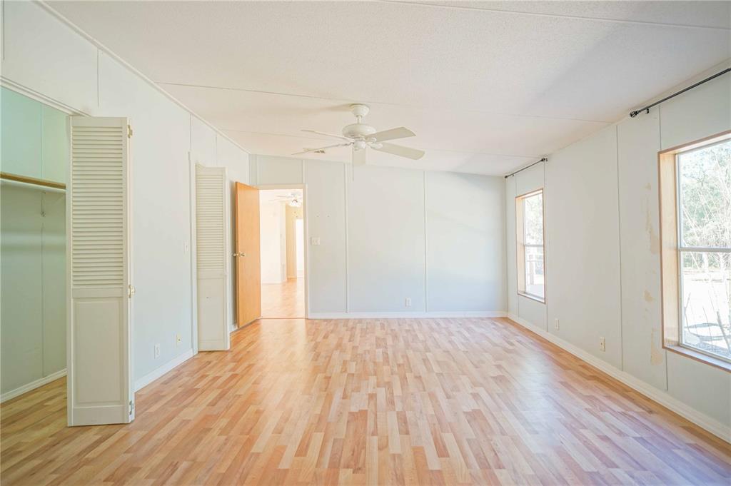 16621 Southwest 45th Street Ocala, FL 34481 - Photo 31 of 52 a view of an empty room with wooden floor and a window