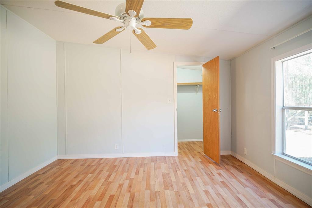 16621 Southwest 45th Street Ocala, FL 34481 - Photo 33 of 52 an empty room with wooden floor fan and windows
