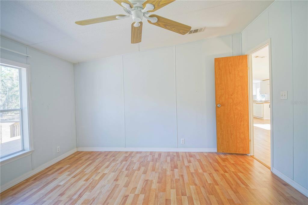 16621 Southwest 45th Street Ocala, FL 34481 - Photo 34 of 52 an empty room with a window and wooden floor
