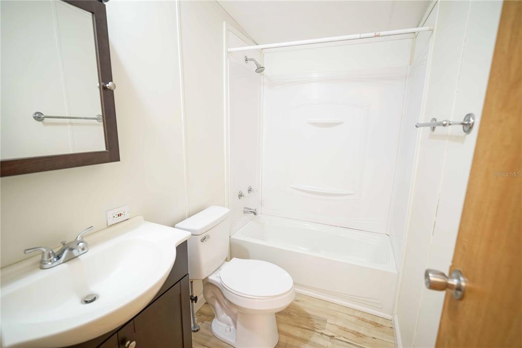 16621 Southwest 45th Street Ocala, FL 34481 - Photo 35 of 52 a bathroom with a sink toilet and shower