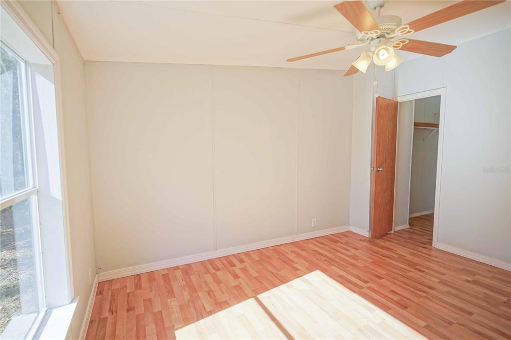 16621 Southwest 45th Street Ocala, FL 34481 - Photo 38 of 52 a view of a room with wooden floor and a ceiling fan