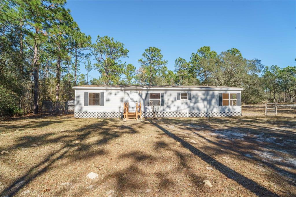 16621 Southwest 45th Street Ocala, FL 34481 - Photo 8 of 52 a view of a yard in front of a house with a large tree