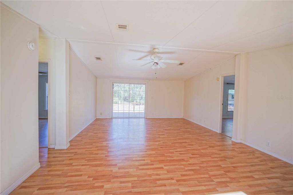 16621 Southwest 45th Street Ocala, FL 34481 - Photo 9 of 52 a view of an empty room with wooden floor and a window