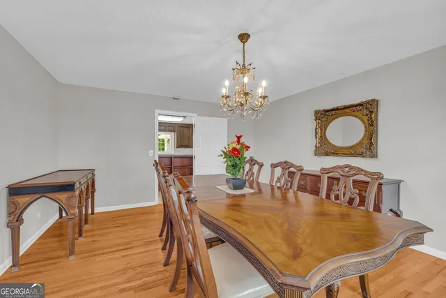 a bathroom with a granite countertop sink a toilet and a window