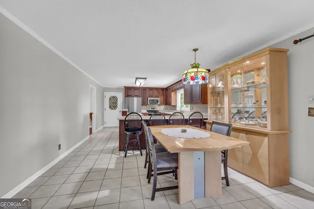 a view of a dining room with furniture chandelier and wooden floor
