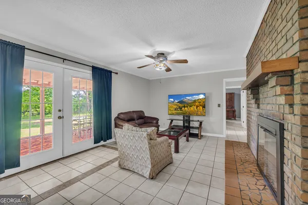 a dining room with furniture a chandelier and wooden floor