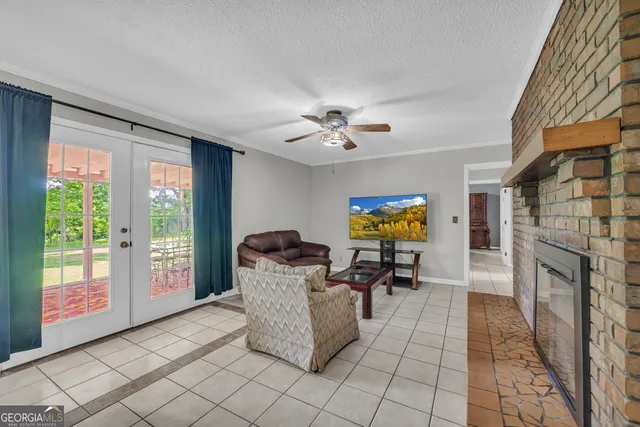 a dining room with furniture a chandelier and wooden floor